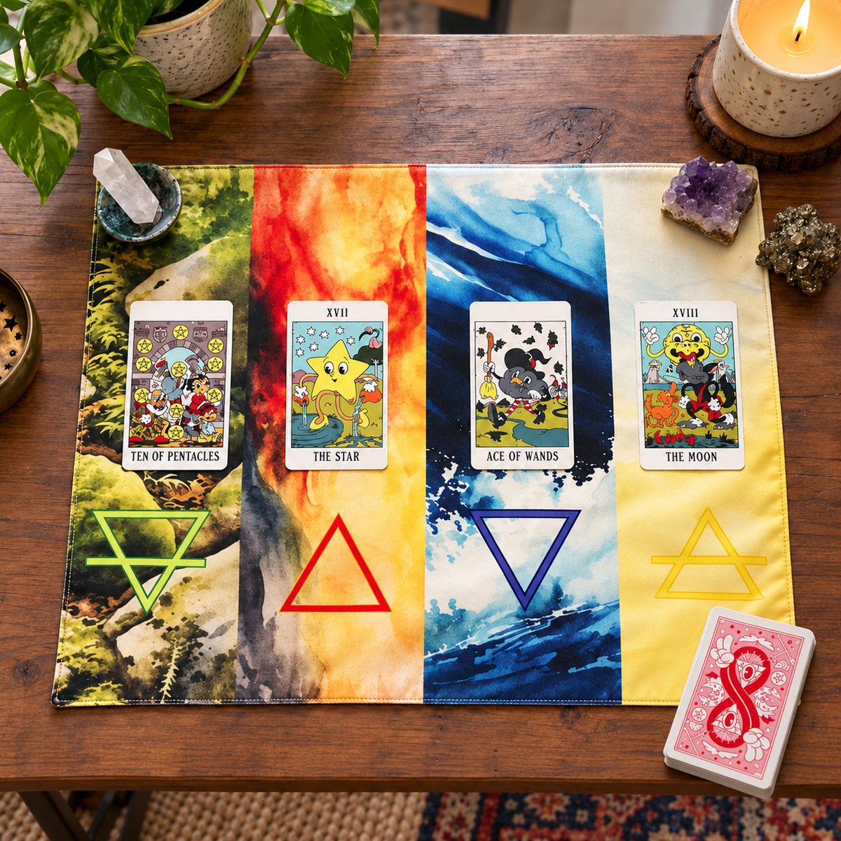 Four Elements tarot cloth with watercolor Earth, Fire, Water, and Air panels and alchemical symbols, displayed with tarot cards and crystals on a wooden table.